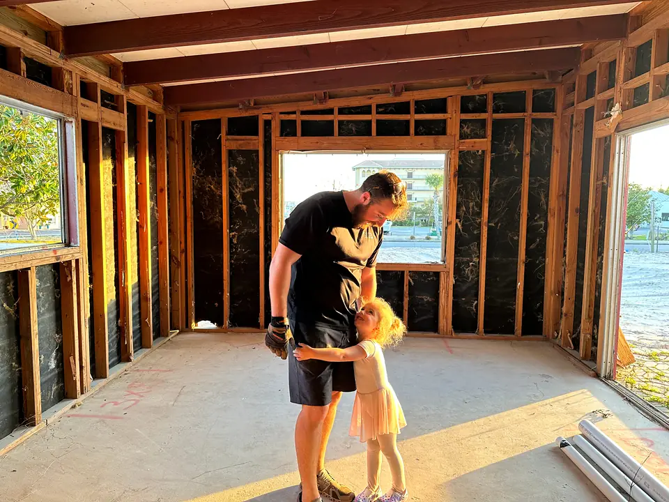 Inside the house during the remodel, framed walls and afternoon sun