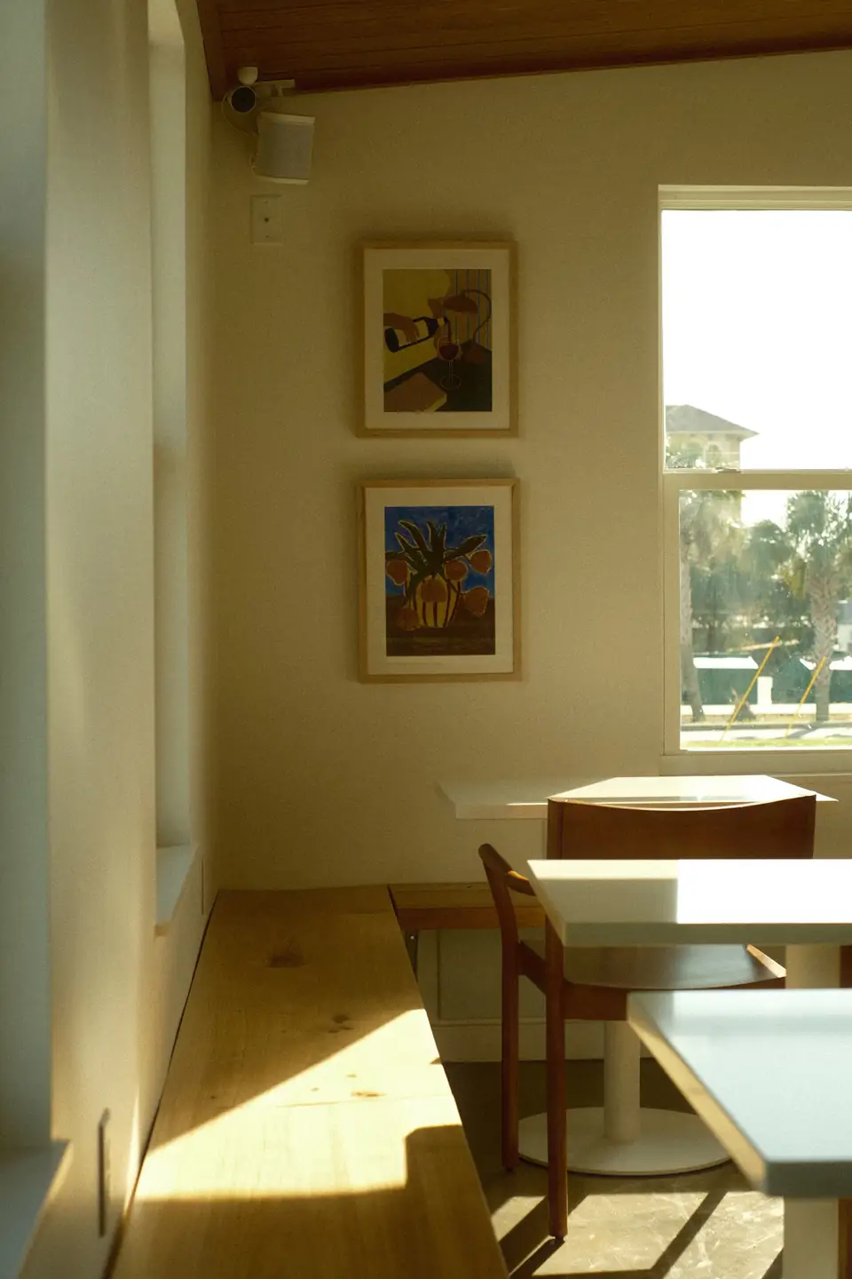 A finished sunny corner of the cafe with framed art