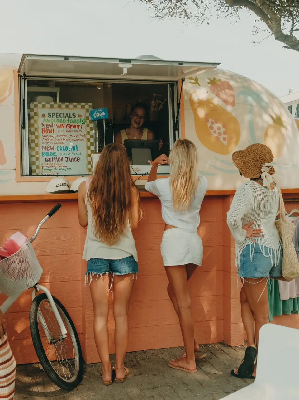 Friends ordering at the Wild Nectar Airstream window in Seaside